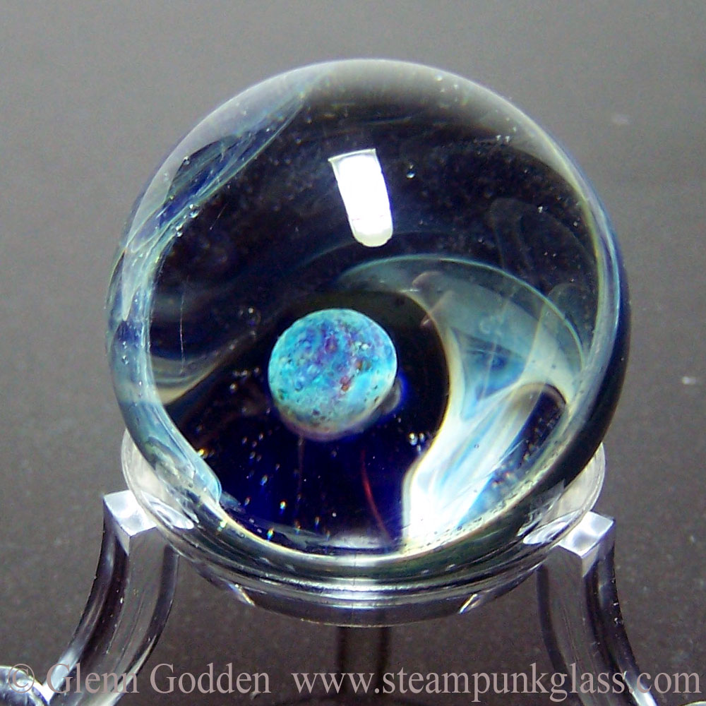 Blue planet space marble by Glenn Godden who handmakes solid glass space marbles