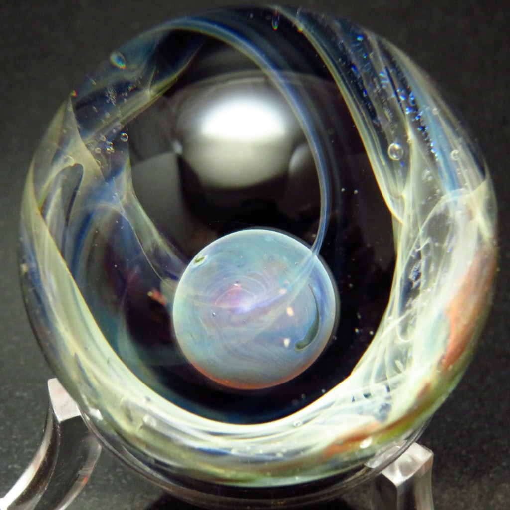 Handmade glass marble with space theme