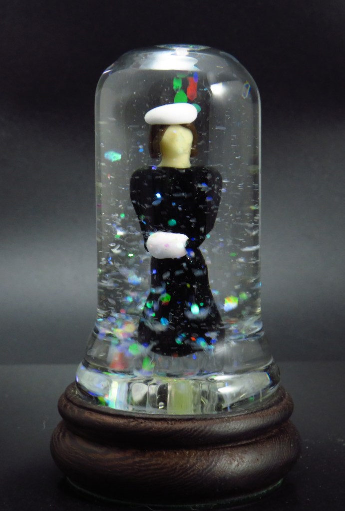 Snow globe in handworked glass, women, pyrex glass figure and case, with wooden base